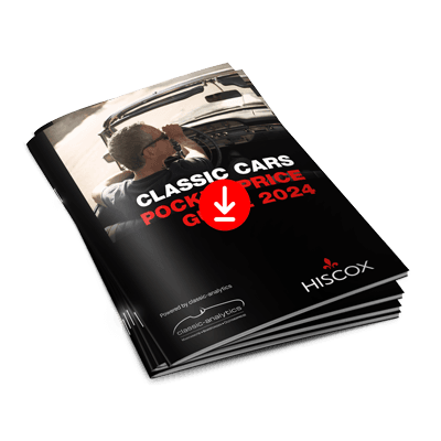 Ein Stapel von Broschüren mit dem Titel 'CLASSIC CARS POCKET PRICE GUIDE 2023'. Auf dem Cover ist ein klassisches weißes Auto abgebildet. Unten rechts steht 'HISCOX WISSEN VERSICHERT'