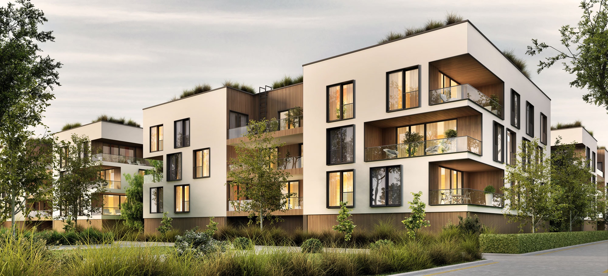 Moderne Wohngebäude mit beleuchteten Wohnungen und Grünflächen