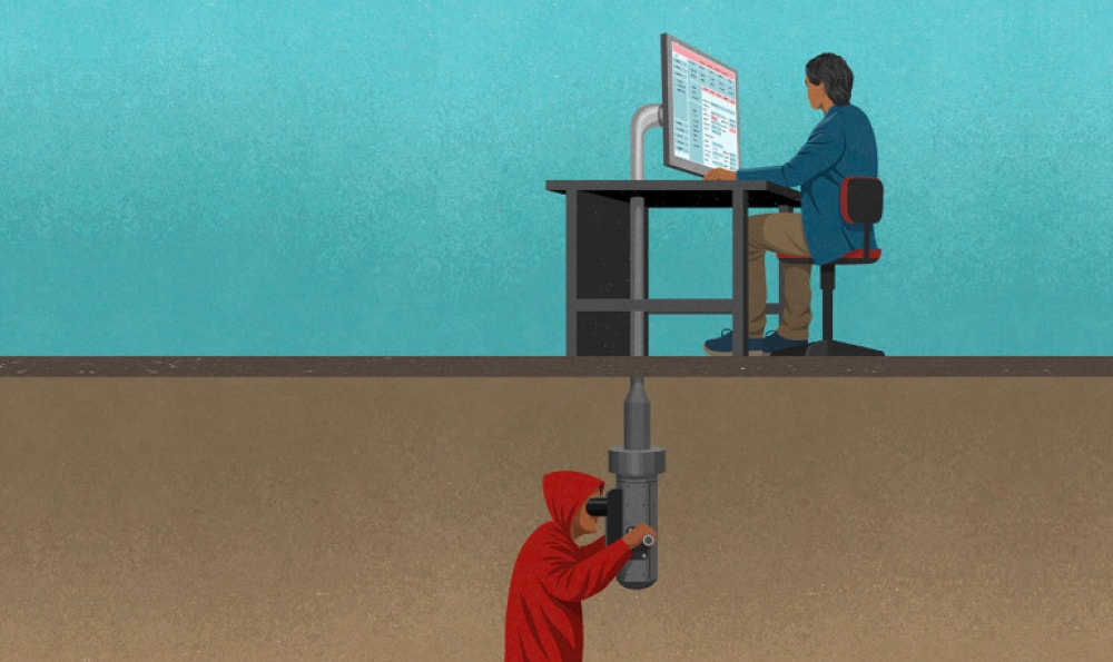 Eine Illustration zeigt eine Person, die an einem Schreibtisch sitzt und auf einen Computerbildschirm schaut. Unter der Erde befindet sich eine andere Person in einem roten Kapuzenpullover, die ein großes Bohrgerät hält und nach oben richtet